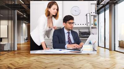 Businessman and businesswoman working together Wall mural