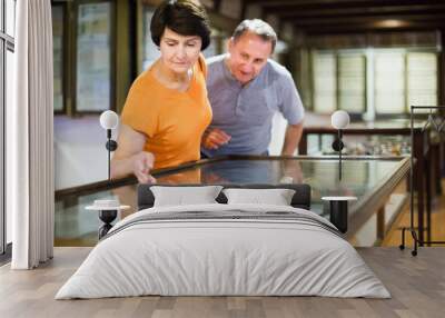 cheerful senior couple examining objects applied art in museum Wall mural