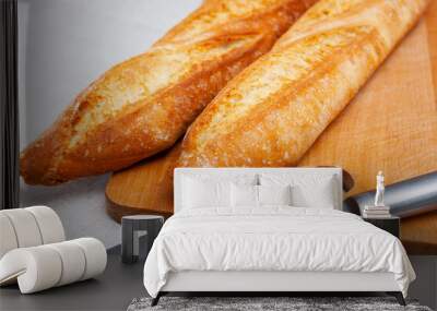 Closeup of two long thin French loaves on wooden surface. Fresh baked goods Wall mural