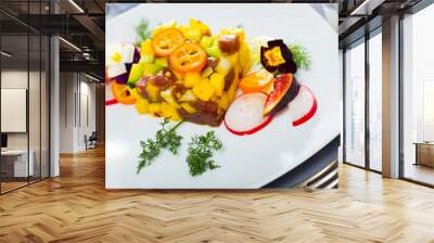 Colorful fish tartare with raw tuna, chopped mango and avocado garnished with cumquat, figs, radish, dill and flowers Wall mural