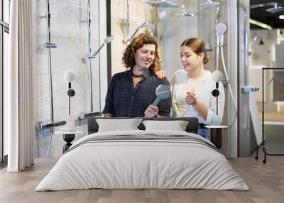 Confident man and woman choosing shower system together in hardware store Wall mural