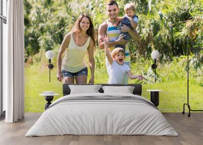 family of four in sunny park Wall mural