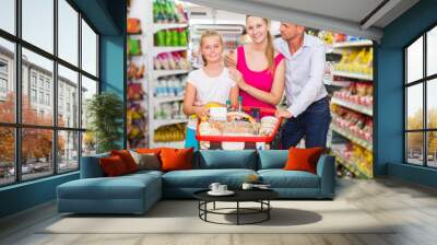 Family standing with purchases Wall mural