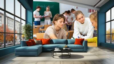 Fellow students having group work tasks during school day Wall mural