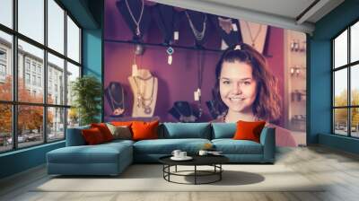 Female choosing necklace and bracelets in the shop Wall mural