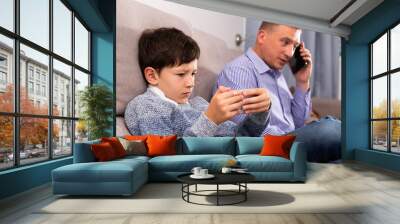 Focused boy with phone Wall mural