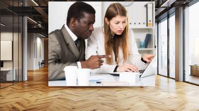 Focused international business team working with computer in modern office Wall mural