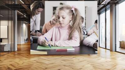 Girl and  children in elementary age at drawing lesson Wall mural