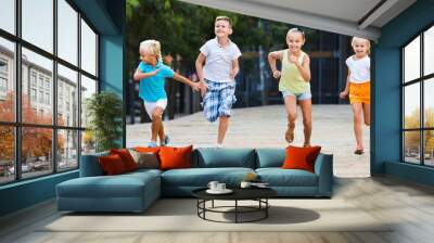 Group of  children running outdoors in city street Wall mural