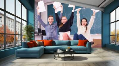 Group portrait of cheerful teen students in auditorium delighted with successful exam results Wall mural