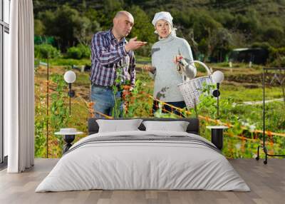 Happy couple with garden tools in garden. High quality photo Wall mural