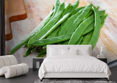 Healthy nutrition concept. Flat pods of raw helda beans on wooden background Wall mural