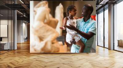 Man and his daughter looking at exhibits Wall mural