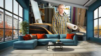 Man consumer choosing carpet in a hardware store Wall mural