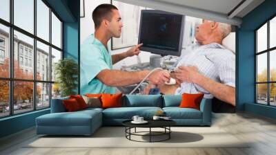 man sonographer examining male patient Wall mural