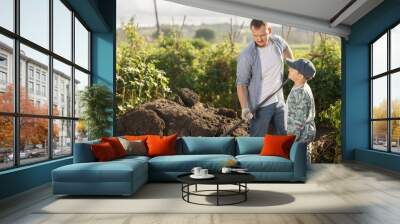 Man with son work with land on a farm. Farmer prepares the land and fertilizes it before planting. Compost preparation on the garden Wall mural