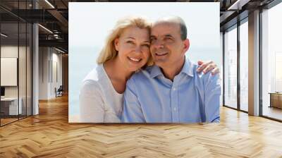 Mature woman and senior at sea beach on vacation smiling Wall mural