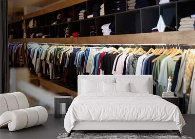 Men clothing shop,  casual clothes on hangers and shelves in apparel store Wall mural