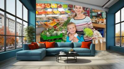 Mother with little boy buying broccoli Wall mural