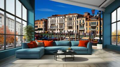 Motor boats parking in Grand Canal in Venice on background of impressive architecture of ancient buildings on banks of canal Wall mural