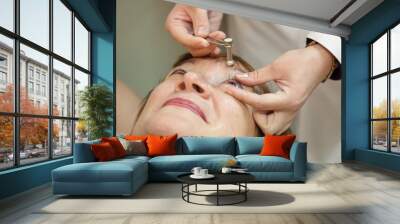 Ophthalmologist measures the  ocular tension Wall mural