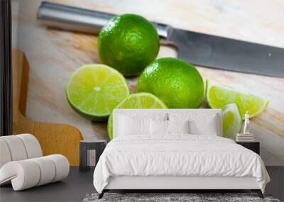 Picture of cut fresh raw green limes on wooden table in home kitchen Wall mural