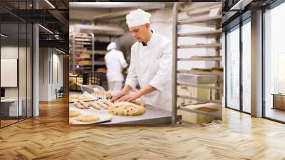 portrait male baker making cookies in bakehouse Wall mural