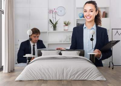 portrait of  business woman holding cardboard in office Wall mural