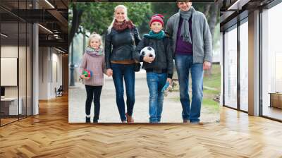 portrait of family with two kids outdoors. Wall mural