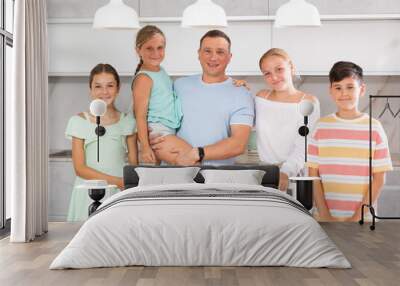 Portrait of friendly father with 3 daughters and 1 son posing together Wall mural