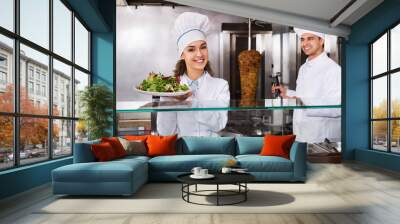 Portrait of two hospitable chefs with kebab Wall mural