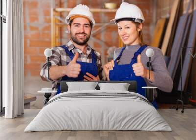 Portrait of two successful workers in uniform inside brick cottage Wall mural