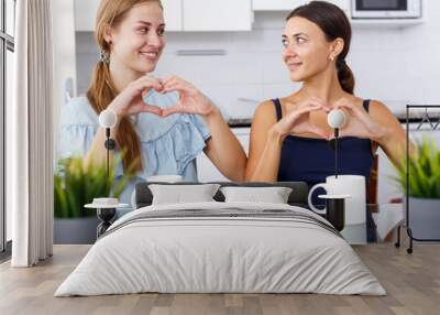 Portrait of two young friendly women Wall mural