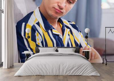 Portrait of young man in home interior Wall mural