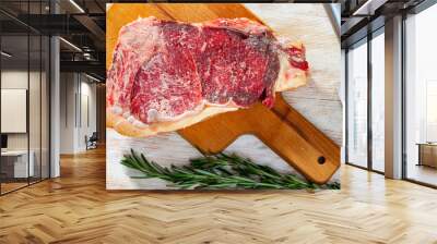 Raw beef entrecote on wooden board with rosemary Wall mural