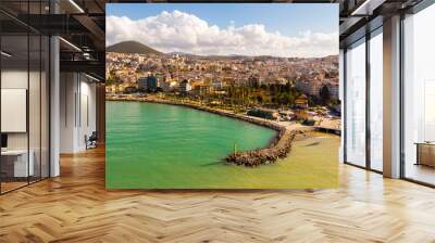 Scenic aerial view of modern cityscape of Kusadasi city along shoreline of Aegean Sea on sunny winter day, Turkey Wall mural