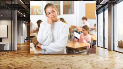 Stressed cute girl feeling upset after getting bad mark at secondary school in class room Wall mural