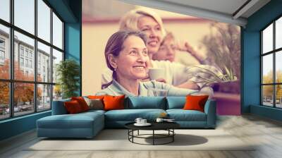 Three women drinking tea at balcony Wall mural