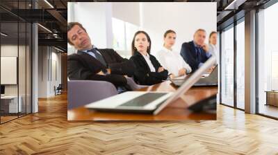 Tired middle aged mature white businessman in formal suit napping during corporate team meeting sitting at table in conference room Wall mural