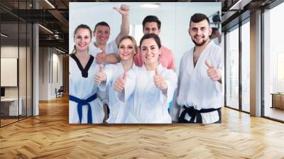 trainees expressing interest in attending karate class Wall mural