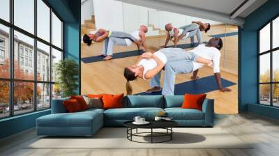 Two couples of young adult people practicing yoga lesson with partner at studio Wall mural