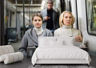 Two women in the cabin of city bus. High quality photo Wall mural