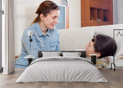 woman caring for sick mature mother at home Wall mural