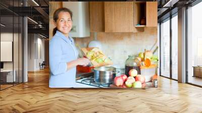 woman cooks applesauce jam Wall mural