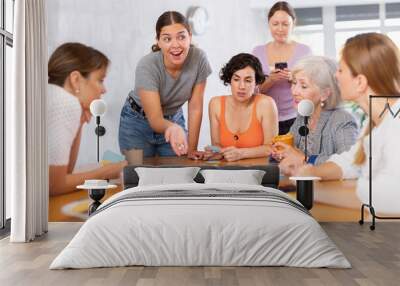 Women spend time over cup of coffee and playing logical board game. concept of development, mental activity in playful way Wall mural