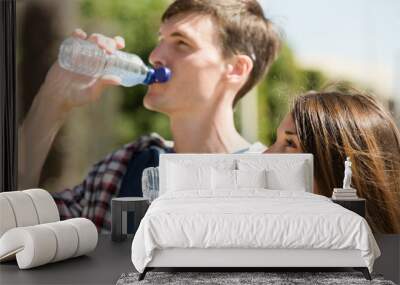 Young couple drink water Wall mural