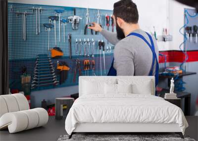 Young man is ready to use his tools Wall mural