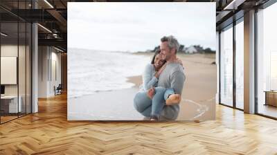  middle-aged couple walking on the beach Wall mural