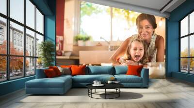 a mother and her daughter are working a pastry with a rolling pin Wall mural