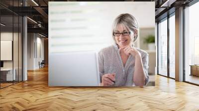 a  senior woman with glasses, who is studying  english lessons Wall mural